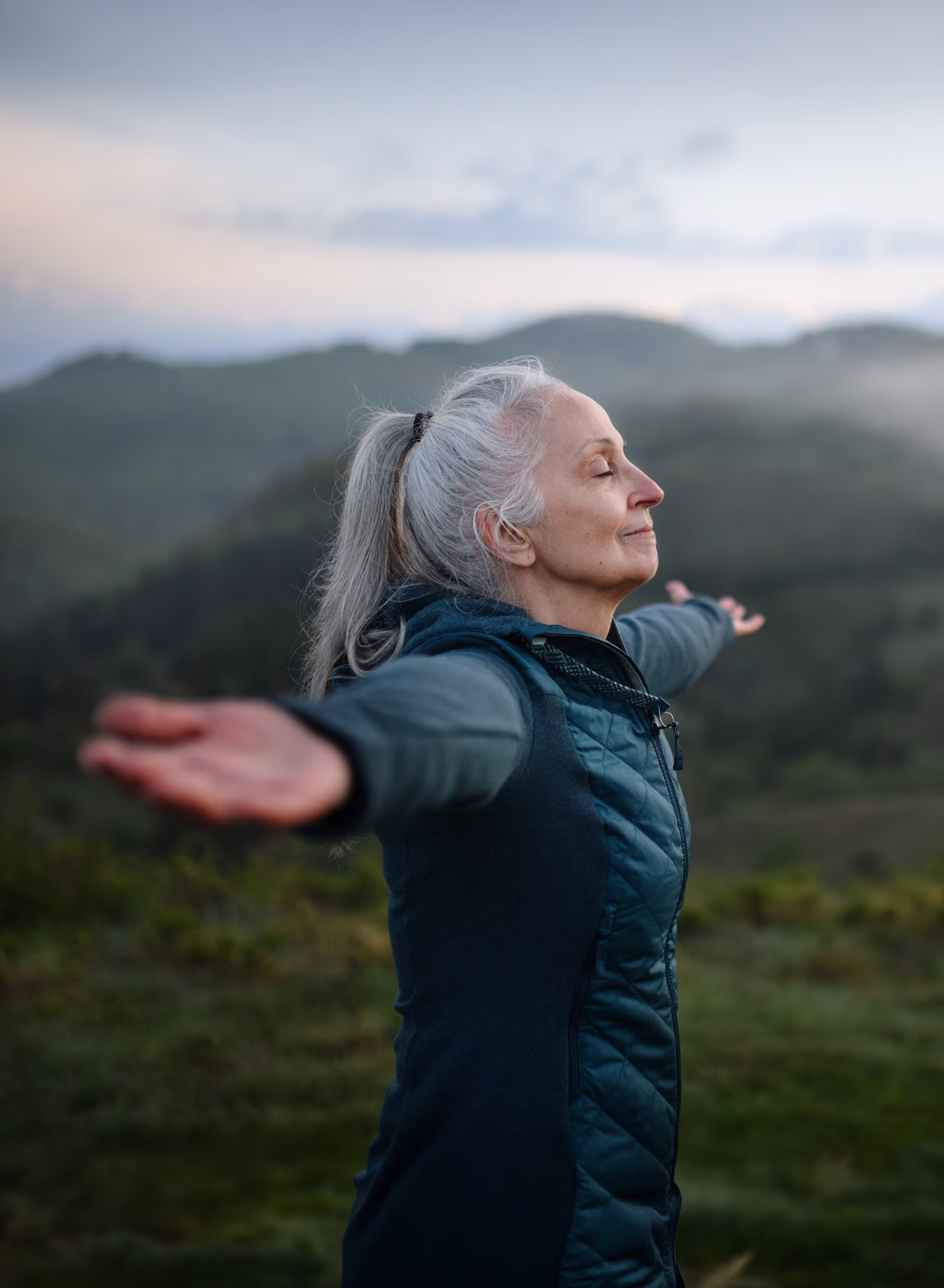 Woman on top of mountain, surveying the land.